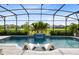 Relaxing screened pool with waterfall feature and comfortable lounge chairs, perfect for outdoor entertaining at 13807 Tybee Beach Ln, Orlando, FL 32827