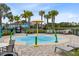 Outdoor community splash pad with palm trees, seating, and easy access to nearby amenities at 13807 Tybee Beach Ln, Orlando, FL 32827