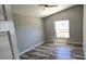 Comfortable bedroom with vaulted ceiling, luxury vinyl flooring, and a bright window offering ample natural light at 159 Piccolo Way, Davenport, FL 33896