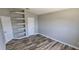 Relaxing bedroom featuring fresh paint, updated flooring, and built-in shelving for storage and display at 159 Piccolo Way, Davenport, FL 33896