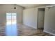 Spacious living room featuring luxury vinyl flooring and a sliding glass door to the outdoor space at 159 Piccolo Way, Davenport, FL 33896