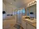 Bright bathroom features a soaking tub, glass enclosed shower, and a large vanity at 15910 Mercott Ct, Clermont, FL 34714