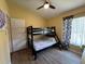 Bright bedroom featuring a bunk bed, ceiling fan, and neutral wall colors at 15910 Mercott Ct, Clermont, FL 34714