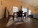 Formal dining area with high ceilings, natural light, and elegant wood flooring at 15910 Mercott Ct, Clermont, FL 34714