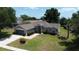 Beautifully landscaped front yard leading to the home's inviting entrance and attached garage at 15910 Mercott Ct, Clermont, FL 34714