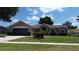 Charming single-story home featuring a well-manicured lawn and attached two-car garage at 15910 Mercott Ct, Clermont, FL 34714