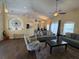 Open-concept living room with hardwood floors and comfortable seating area, perfect for entertaining at 15910 Mercott Ct, Clermont, FL 34714