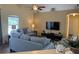 Cozy living room featuring hardwood floors and ample natural light, creating a welcoming atmosphere at 15910 Mercott Ct, Clermont, FL 34714