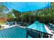 Beautiful backyard with an outdoor kitchen, dining area, fire pit, and mature trees at 1624 E Livingston St, Orlando, FL 32803