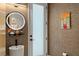 Modern bathroom featuring a unique sink, decorative mirror, and stylish fixtures with neutral textures at 1624 E Livingston St, Orlando, FL 32803