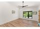 Bright, minimalist bedroom with hardwood floors, a large window, and recessed lighting at 1624 E Livingston St, Orlando, FL 32803