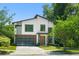 Modern home with a glass garage door, contemporary design, and lush landscaping at 1624 E Livingston St, Orlando, FL 32803