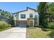 Stunning modern home featuring a glass garage door, crisp white accents, and professional landscaping at 1624 E Livingston St, Orlando, FL 32803