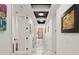 Bright hallway with marble floors, recessed lighting, and black ceiling accents, leading to a modern wood door at 1624 E Livingston St, Orlando, FL 32803