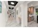 Well-lit hallway features marble floors and leads to a conveniently located laundry room at 1624 E Livingston St, Orlando, FL 32803