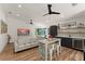 Open living room featuring a wet bar area, comfortable seating, and modern ceiling fans at 1624 E Livingston St, Orlando, FL 32803