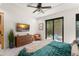 Bright main bedroom with a cozy sitting area, access to backyard, and modern furniture on marble floors at 1624 E Livingston St, Orlando, FL 32803