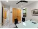Spacious home office with double doors, glass desk, ceiling fan, and bright natural light at 1624 E Livingston St, Orlando, FL 32803