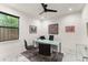 Bright home office featuring a sleek glass desk, modern lighting, and a cozy rug at 1624 E Livingston St, Orlando, FL 32803