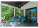 Charming covered patio with an outdoor living space and view of the lush backyard at 1624 E Livingston St, Orlando, FL 32803