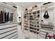 Spacious walk-in closet with custom shelves and drawers, designed to maximize storage and organization with good lighting at 1624 E Livingston St, Orlando, FL 32803