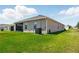 Exterior view of the home with a well-manicured lawn and screened-in porch at 1703 Daystar Dr, Haines City, FL 33844