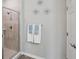 Tiled bathroom featuring glass enclosed shower, a towel rack, and clean design at 1703 Daystar Dr, Haines City, FL 33844