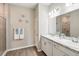 Bathroom showcasing double sinks, granite countertops, modern fixtures, and decorative elements at 1703 Daystar Dr, Haines City, FL 33844