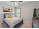 Cozy bedroom featuring a queen-sized bed, neutral walls, and a window with natural light at 1703 Daystar Dr, Haines City, FL 33844