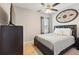 Cozy bedroom with ceiling fan, dark wood furniture and decorative metal wall art at 1703 Daystar Dr, Haines City, FL 33844