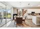 Open dining area flows to outdoor living space and kitchen with stainless steel appliances at 1703 Daystar Dr, Haines City, FL 33844