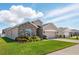 A well-maintained home featuring a manicured lawn and a two-car garage on a sunny day at 1703 Daystar Dr, Haines City, FL 33844