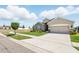 Beautifully landscaped single-story home with a well-manicured lawn and a two-car garage at 1703 Daystar Dr, Haines City, FL 33844