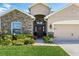 Inviting home with a stone facade, well-kept lawn, and a charming front door at 1703 Daystar Dr, Haines City, FL 33844