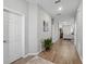 Inviting hallway with wood-look floors and neutral paint that connects to a bright, open living area at 1703 Daystar Dr, Haines City, FL 33844