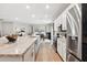 Open kitchen design with stainless appliances, large island, and view to dining area and connected rooms at 1703 Daystar Dr, Haines City, FL 33844