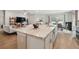 Open concept living area with kitchen island, seamlessly connected to living and dining spaces at 1703 Daystar Dr, Haines City, FL 33844