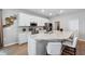 Bright kitchen featuring white cabinets, stainless steel appliances, and a large island with a sink at 1703 Daystar Dr, Haines City, FL 33844