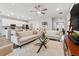 Open-concept living room with a ceiling fan and views into the dining and kitchen areas at 1703 Daystar Dr, Haines City, FL 33844
