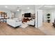 Bright living room with hardwood floors, ceiling fan, stylish decor and comfortable seating at 1703 Daystar Dr, Haines City, FL 33844