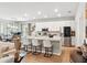 Bright open concept living room flowing into the kitchen with an island and bar stool seating at 1703 Daystar Dr, Haines City, FL 33844