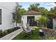 Serene backyard retreat featuring Adirondack chairs, artificial turf, and lush landscaping at 1840 Bryan Ave, Winter Park, FL 32789