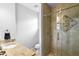 Modern bathroom featuring tiled shower with decorative glass and granite countertops at 1840 Bryan Ave, Winter Park, FL 32789