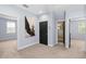 Bedroom featuring neutral carpet, light blue walls and a black door at 1840 Bryan Ave, Winter Park, FL 32789