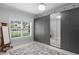 Bright bedroom with large windows, neutral walls, closet system and light wood floors at 1840 Bryan Ave, Winter Park, FL 32789