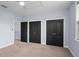 Bedroom featuring neutral carpet, light blue walls and three black doors at 1840 Bryan Ave, Winter Park, FL 32789