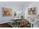 Bright dining area with modern light fixtures, oversized art, and easy access to kitchen bar at 1840 Bryan Ave, Winter Park, FL 32789