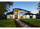 Stunning two-story home boasts a meticulously landscaped yard and elegant modern architectural details at 1840 Bryan Ave, Winter Park, FL 32789