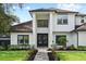 Beautiful two-story home with manicured lawn and inviting entrance, exuding curb appeal at 1840 Bryan Ave, Winter Park, FL 32789