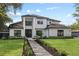 A beautifully landscaped two-story home with a stone walkway at 1840 Bryan Ave, Winter Park, FL 32789